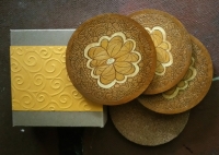 Set of 4 coasters with original design etched into wood with cork bottom. Etched wooden coasters